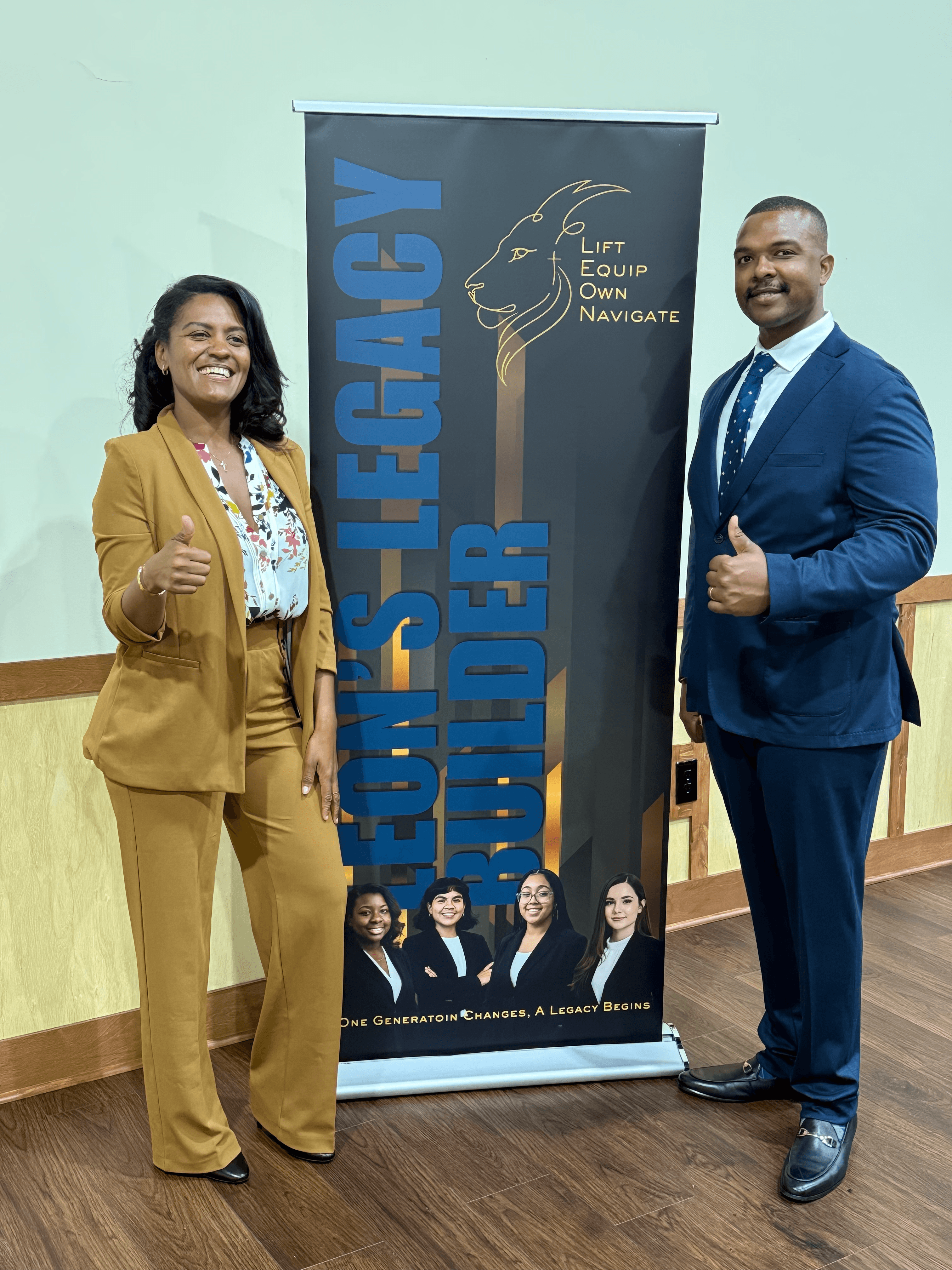 Two professionals in suits give thumbs up beside a Leon's Legacy Builder promotional banner.
